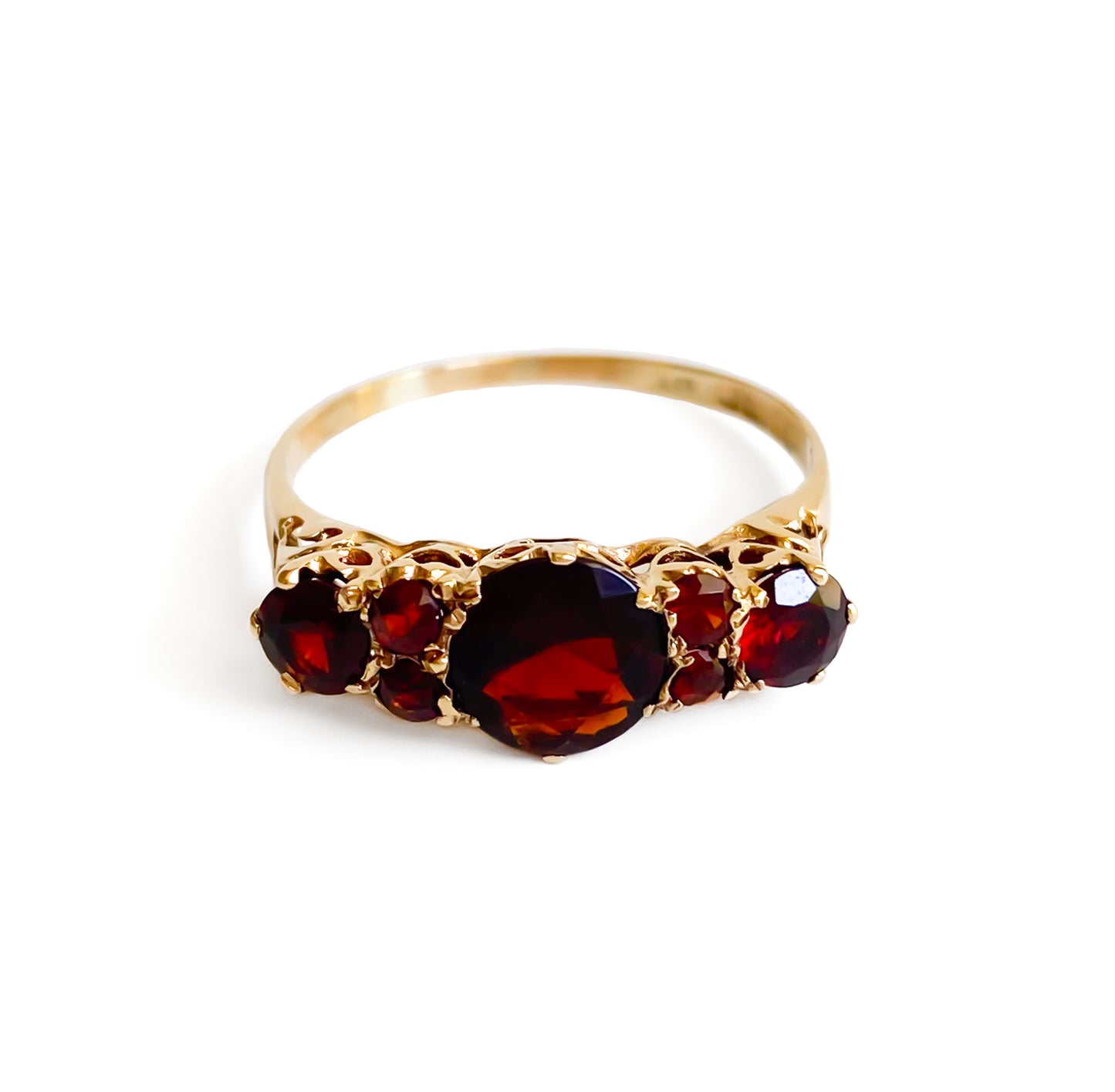 Lovely vintage 9ct yellow gold ring set with seven deep red faceted garnets. England.