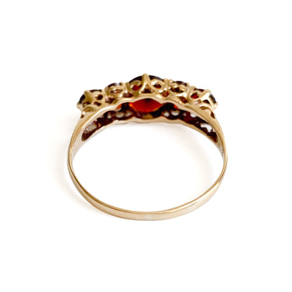 Lovely vintage 9ct yellow gold ring set with seven deep red faceted garnets. England.