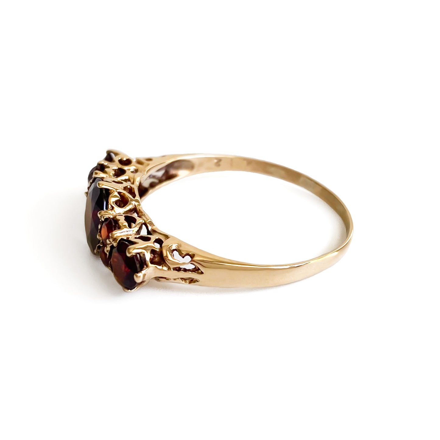 Lovely vintage 9ct yellow gold ring set with seven deep red faceted garnets. England.