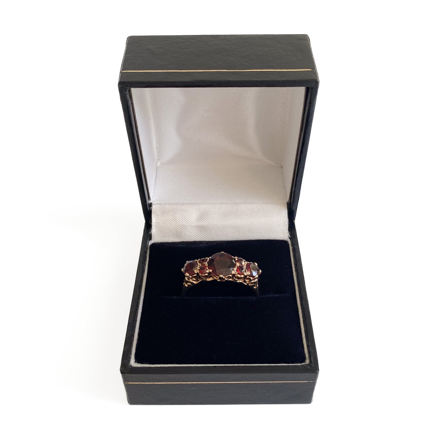 Lovely vintage 9ct yellow gold ring set with seven deep red faceted garnets. England.