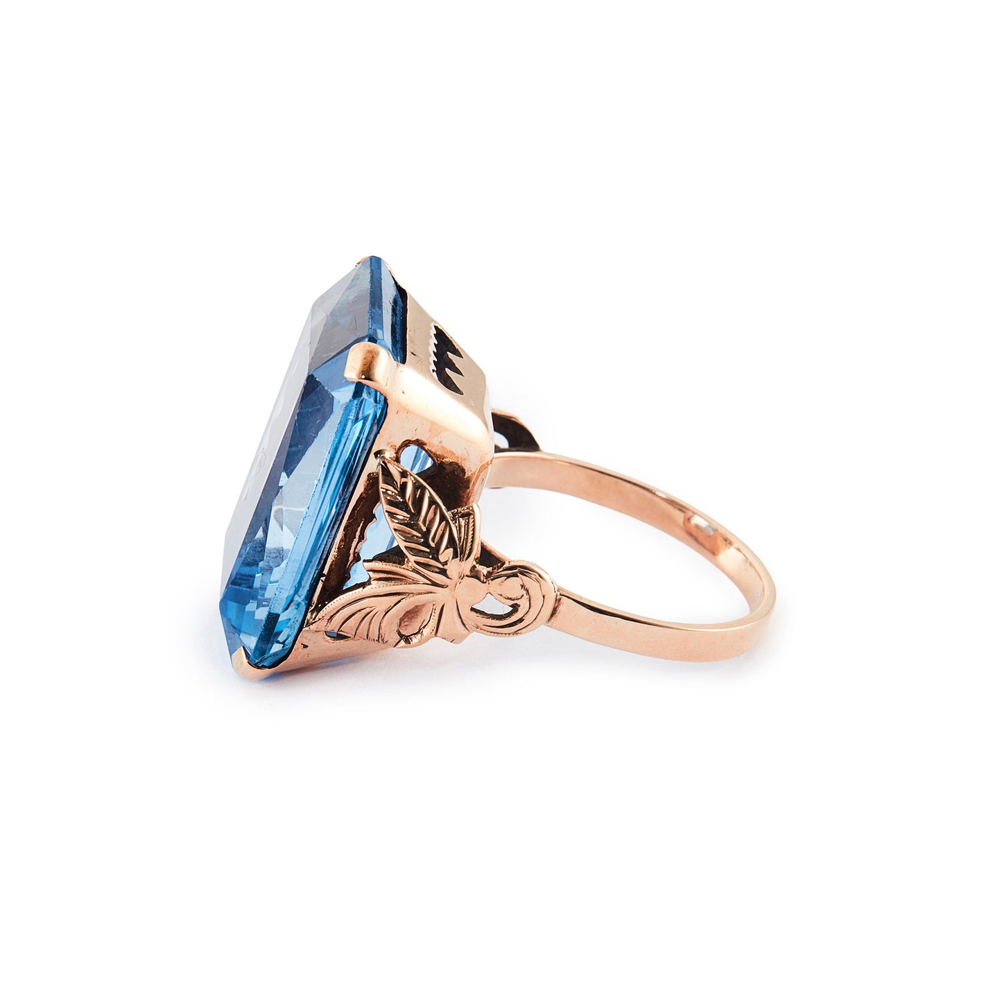 Beautifully faceted deep-blue lab-grown spinel in a lovely 9ct rose gold ring setting with a leaf design.