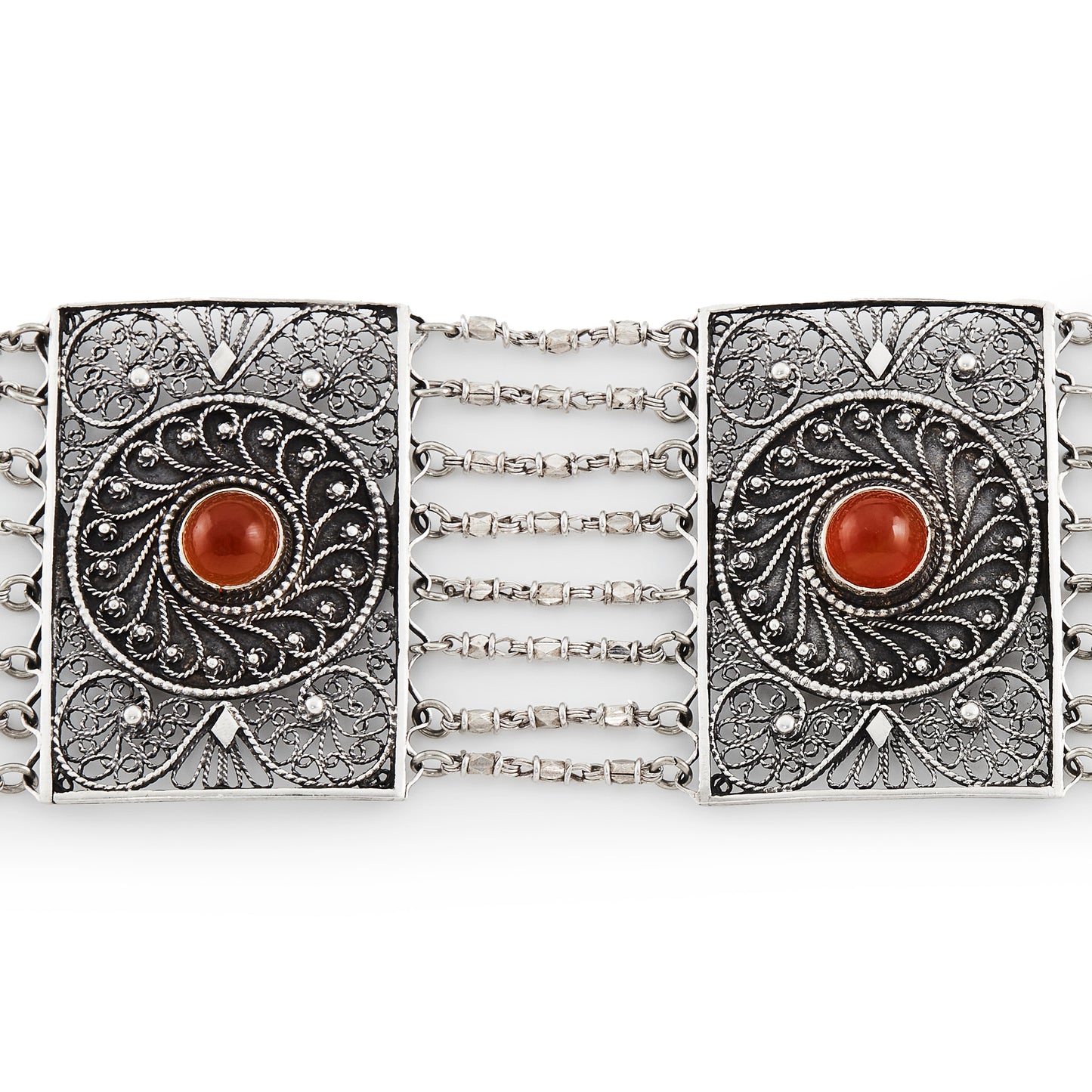 Vintage silver bracelet set with three cabochon carnelian stones. Intricate filigree detail. Turkish.
Maker: Limco