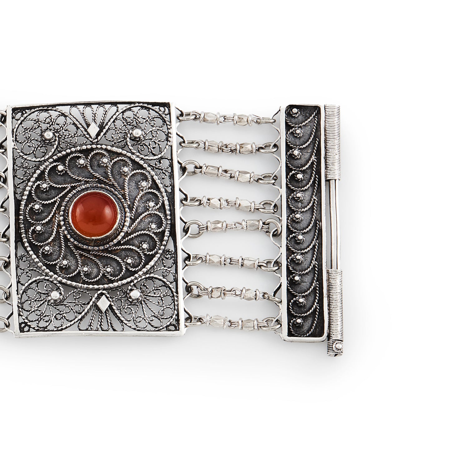 Vintage silver bracelet set with three cabochon carnelian stones. Intricate filigree detail. Turkish.
Maker: Limco
