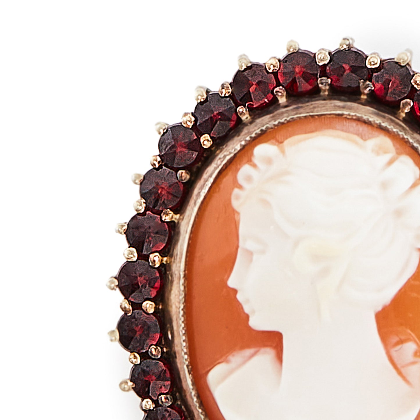 Pretty silver gilt cameo surrounded by twenty-eight deep red faceted Bohemian garnets.