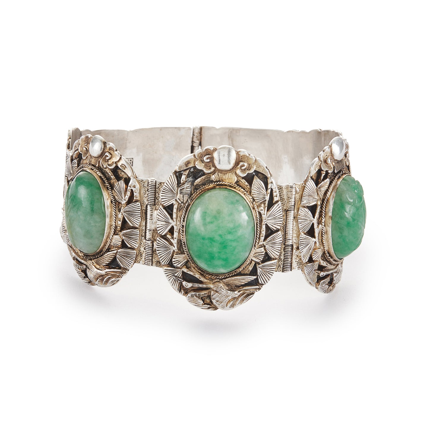 Stunning Chinese silver gilt bracelet set with three oval jade cabochon stones. Two side stones are hand carved with a leaf design. The bracelet is ornately carved with a floral design, also featuring birds and a dragon.