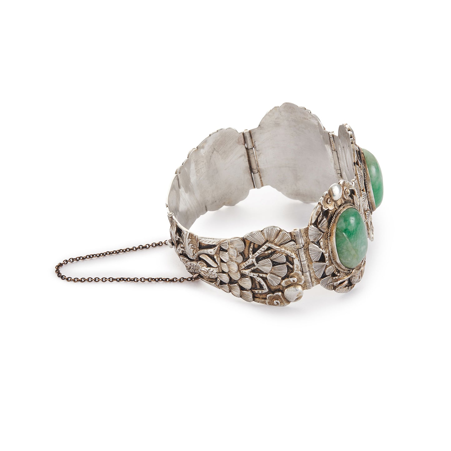 Stunning Chinese silver gilt bracelet set with three oval jade cabochon stones. Two side stones are hand carved with a leaf design. The bracelet is ornately carved with a floral design, also featuring birds and a dragon.