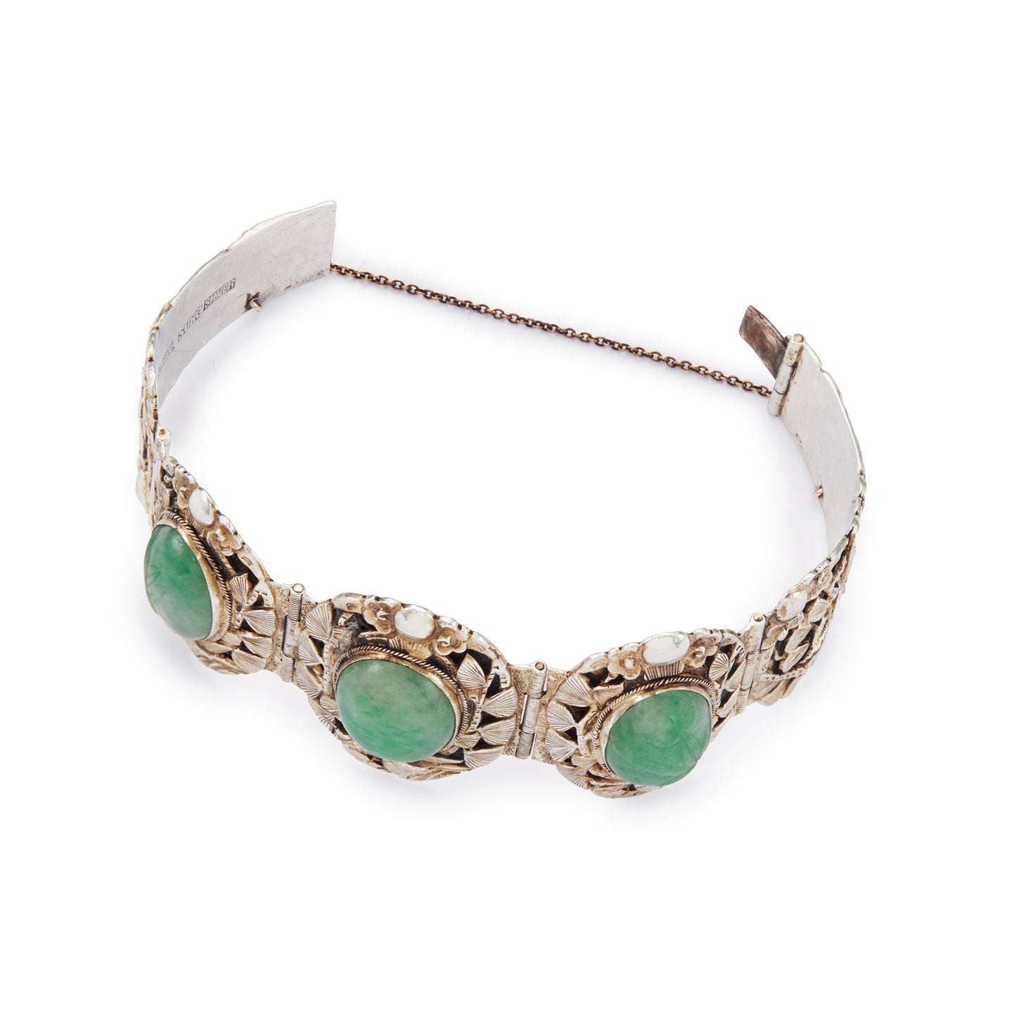 Stunning Chinese silver gilt bracelet set with three oval jade cabochon stones. Two side stones are hand carved with a leaf design. The bracelet is ornately carved with a floral design, also featuring birds and a dragon.