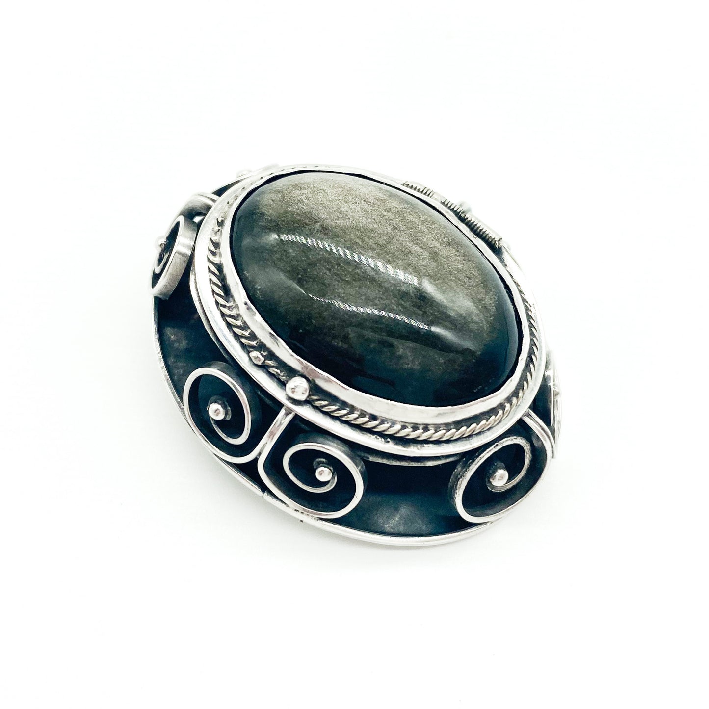 Vintage sterling silver Mexican poison pendant set with a luminescent brown cabochon labradorite stone. Can also be worn as a brooch.