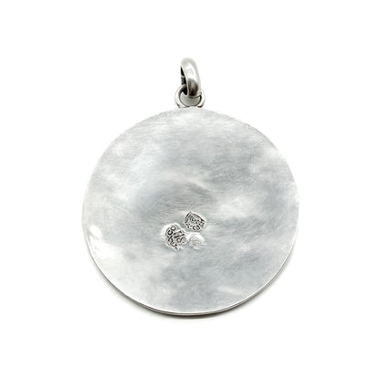 Vintage silver pendant with crushed stone inlay and sun face design. Made in Taxco.