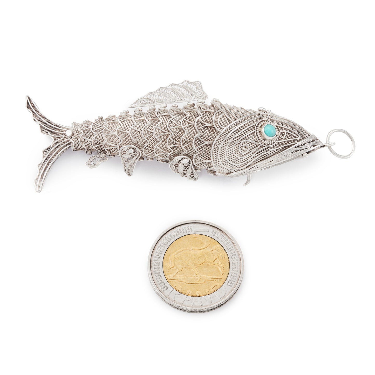 Charming vintage silver filigree spice holder fish pendant with turquoise eyes. The body is articulated with dangling fins.