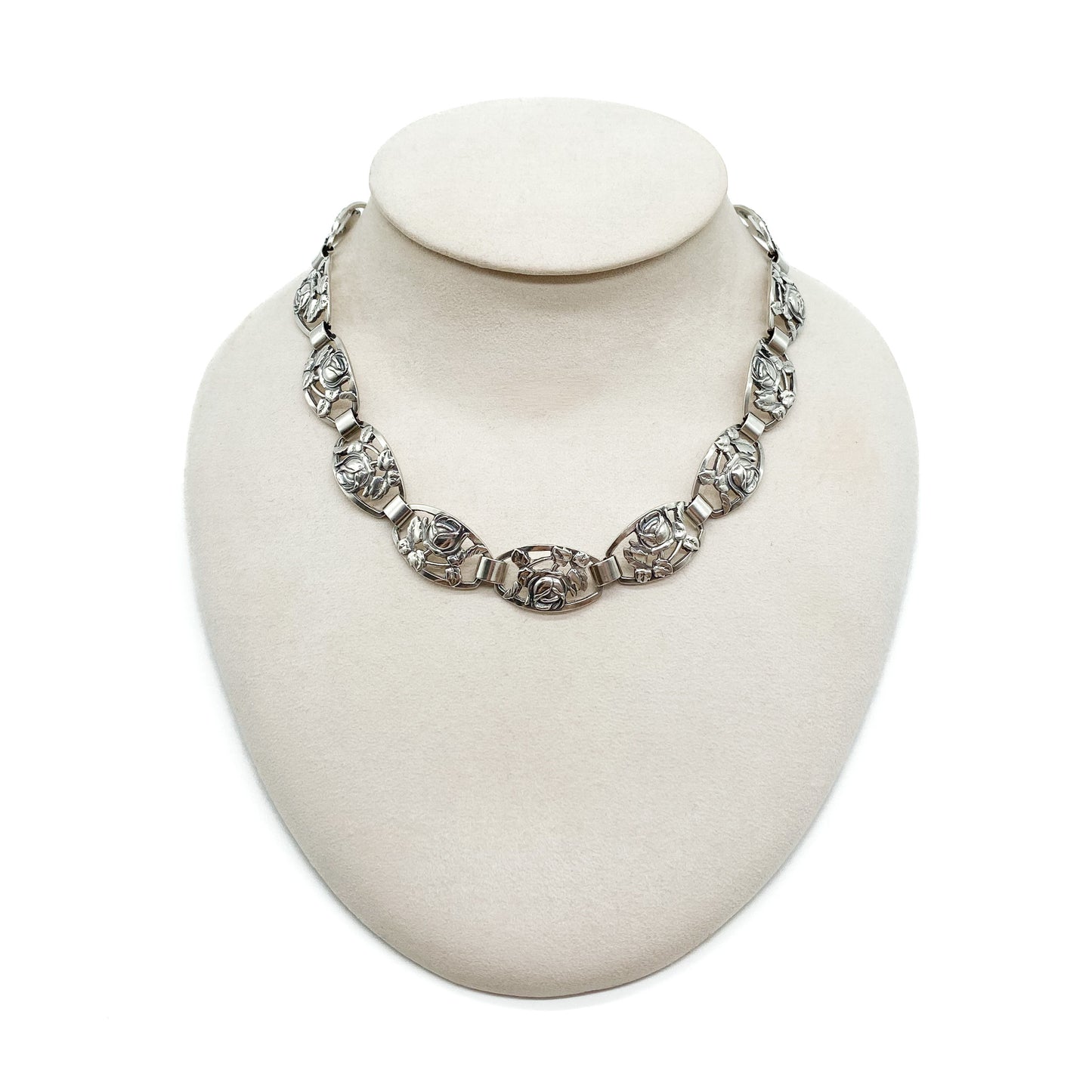 Ornate Danish sterling silver choker with fifteen links, each depicting a rose surrounded by leaves.
