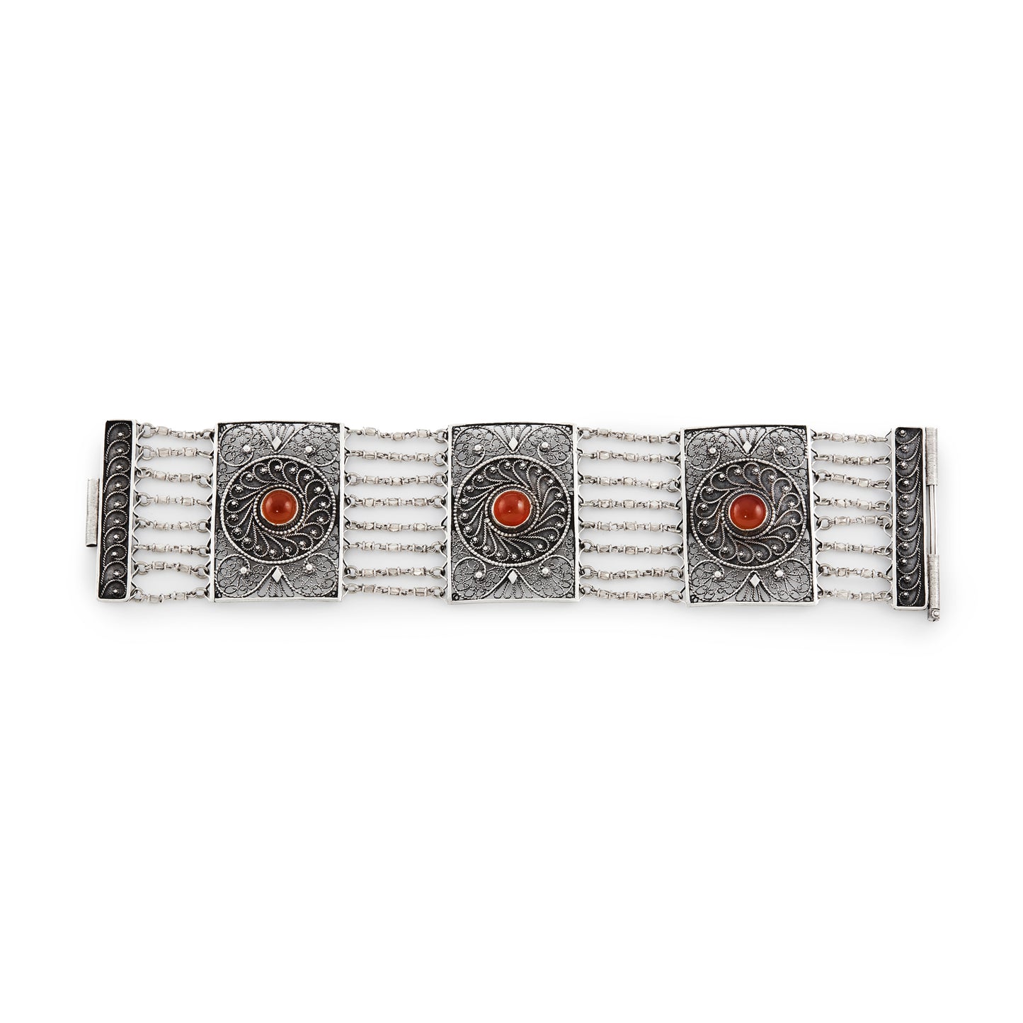 Vintage silver bracelet set with three cabochon carnelian stones. Intricate filigree detail. Turkish.
Maker: Limco