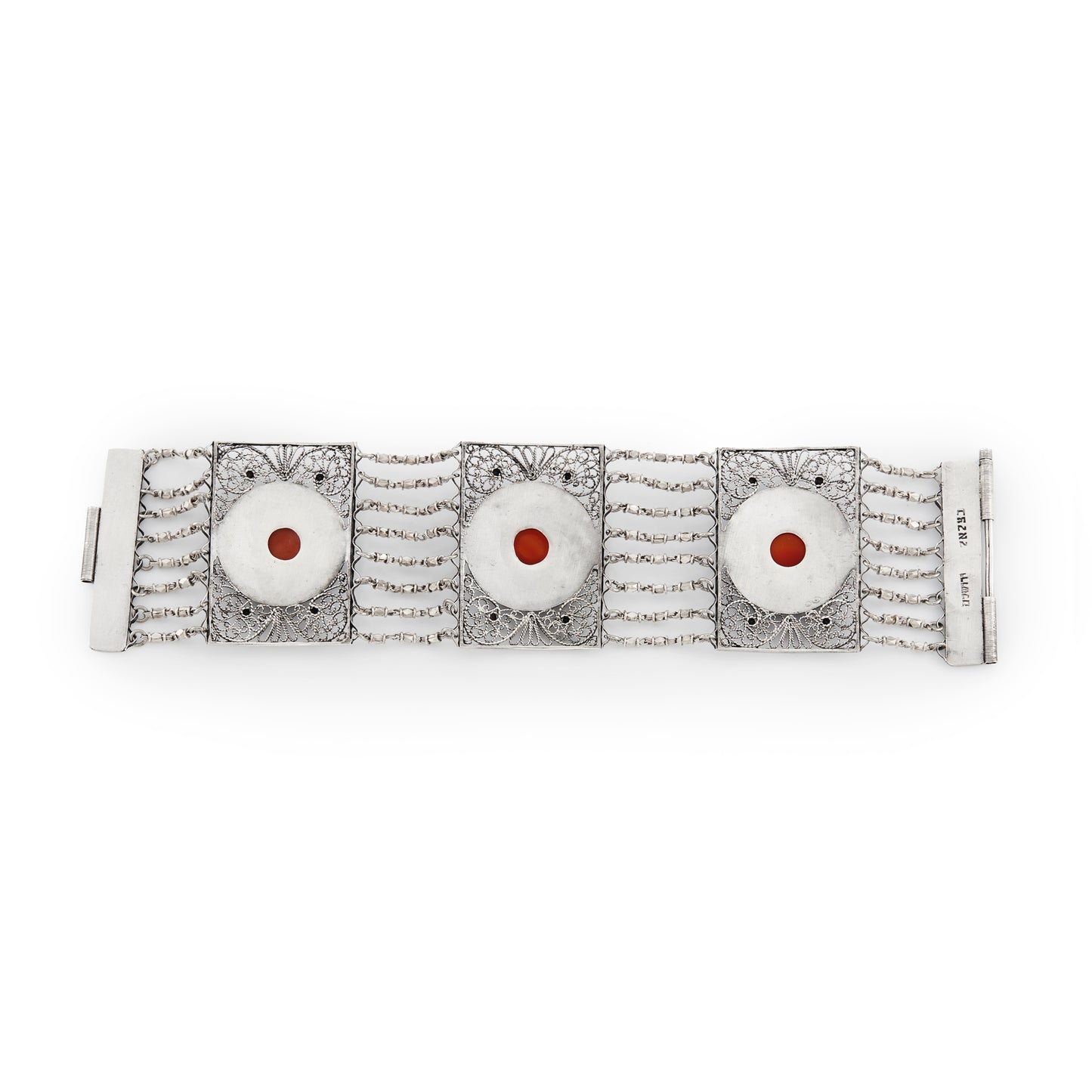 Vintage silver bracelet set with three cabochon carnelian stones. Intricate filigree detail. Turkish.
Maker: Limco
