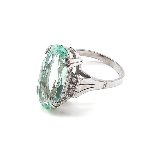 Magnificent 18ct white gold ring set with a beautifully faceted 7ct oval aquamarine and six small diamonds.