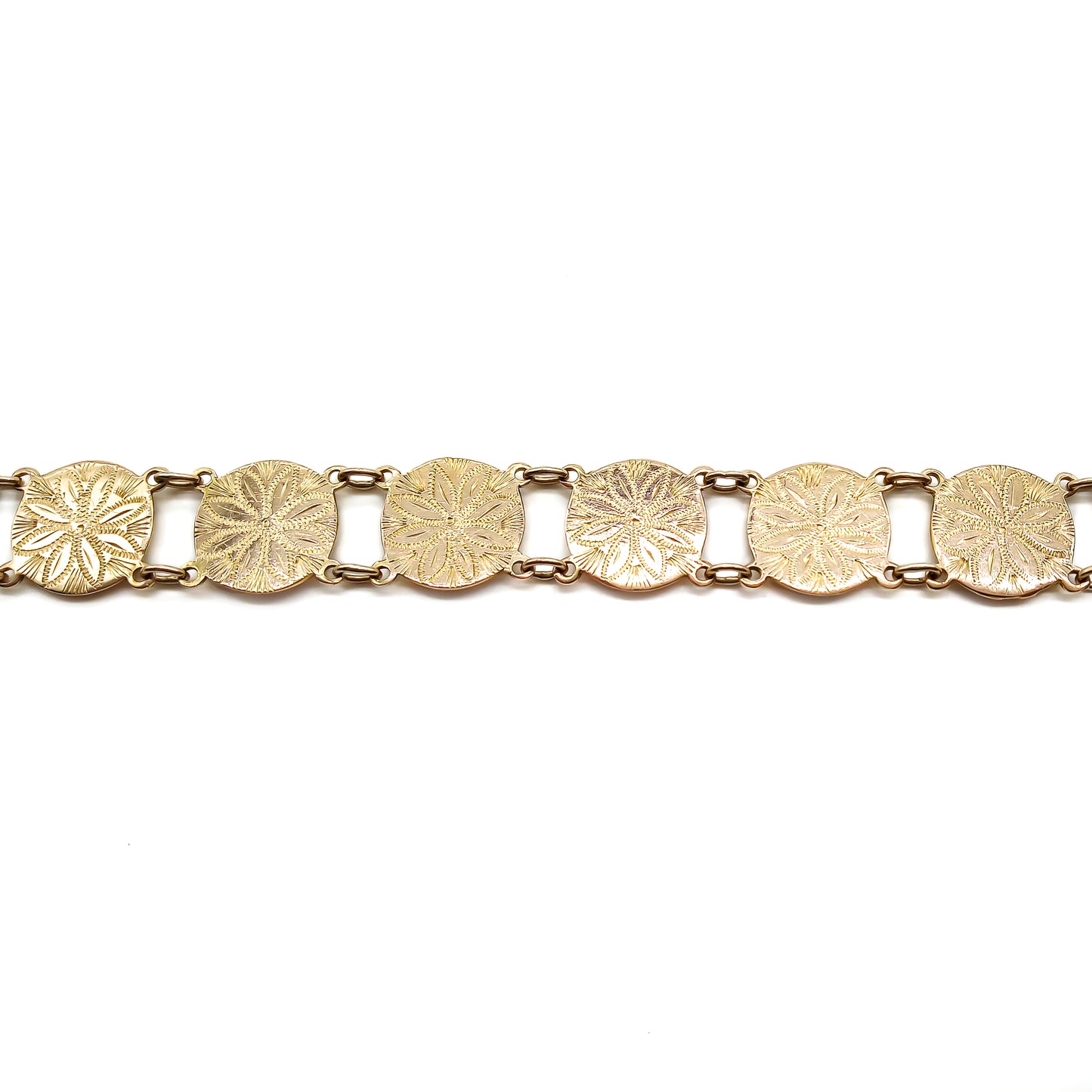 Close-up of an antique 9ct rose gold disc bracelet with lovely engraving. Circa 1940's