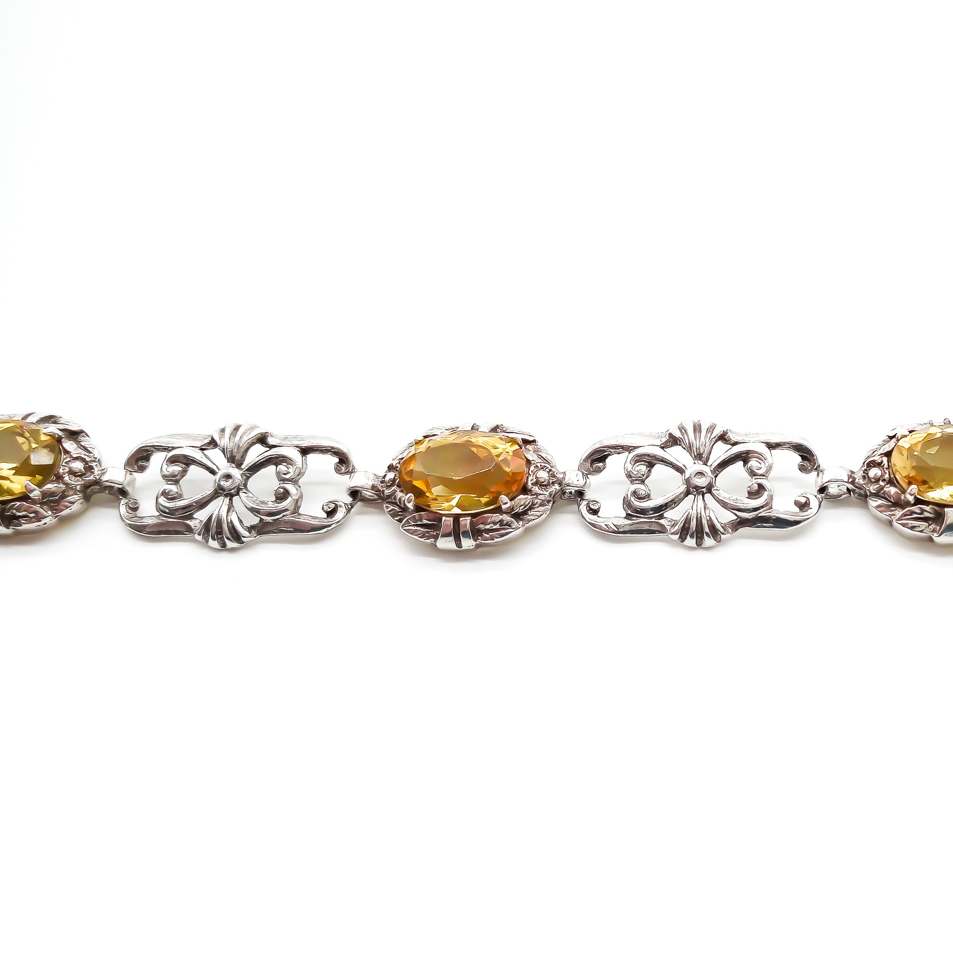 Stunning ornate sterling silver bracelet set with four beautifully faceted oval citrines.
