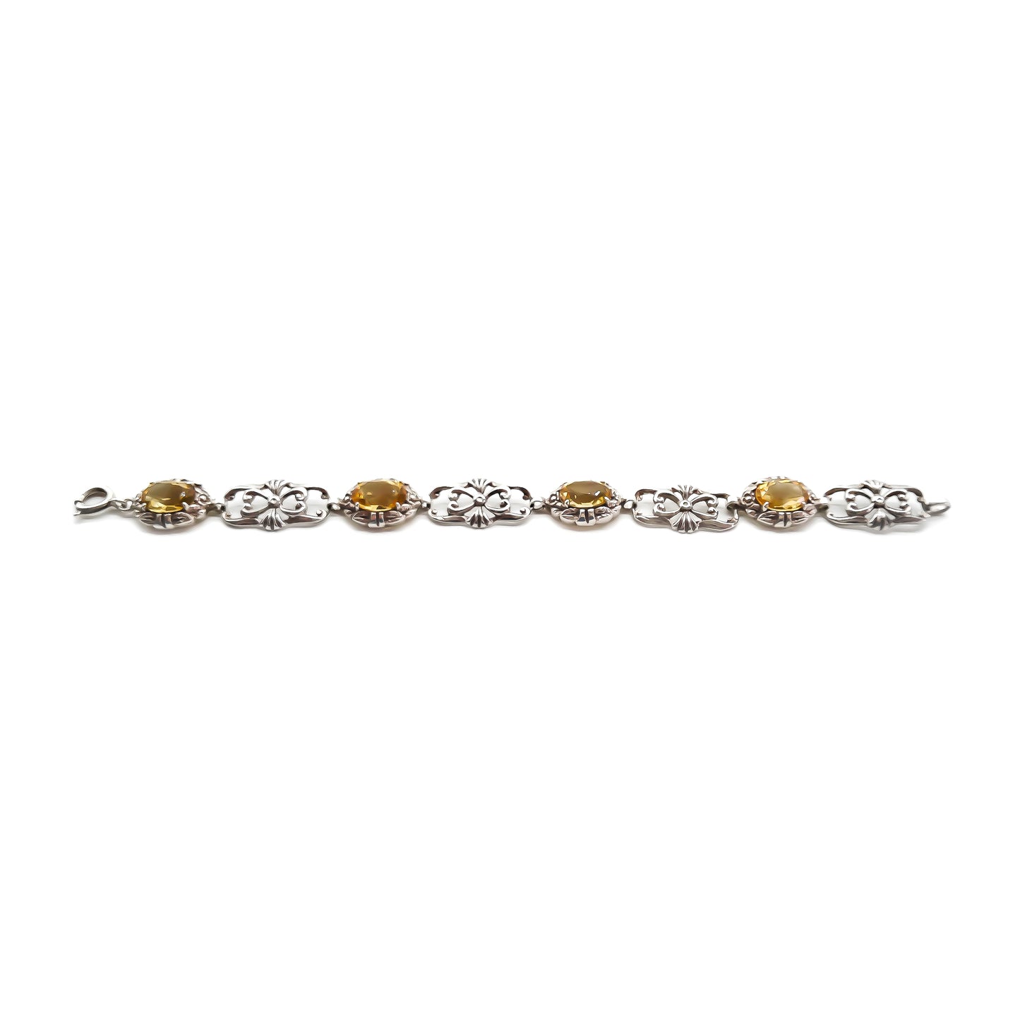 Stunning ornate sterling silver bracelet set with four beautifully faceted oval citrines.
