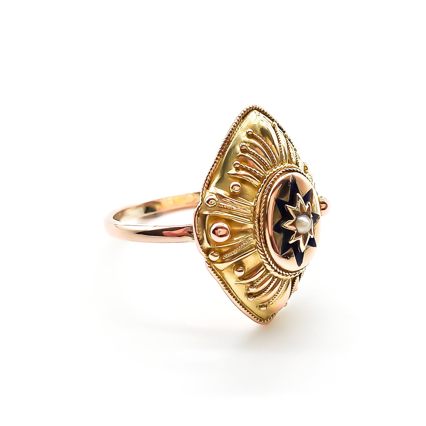 Lovely 15ct yellow gold Victorian ring with ornate detail. The ring is set with a single seed pearl, surrounded by dark blue enamelling in the shape of a star. Later shank.