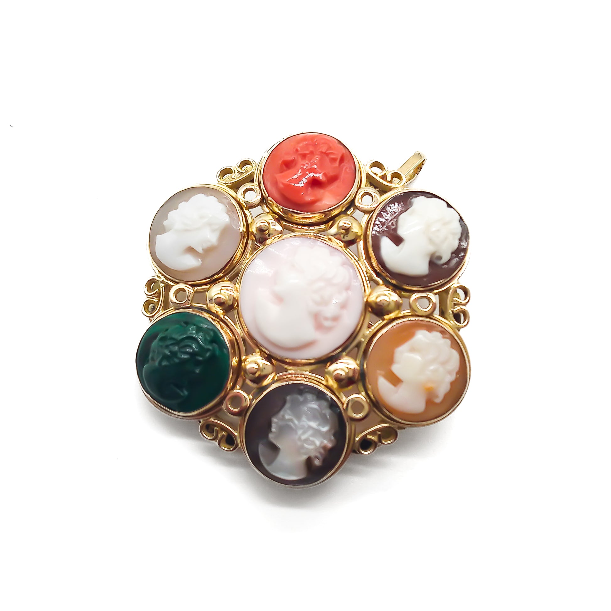 Unique 14ct yellow gold pendant/brooch set with a variety of seven small cameos, including one coral and one chrysoprase. Beautiful scroll work on setting.