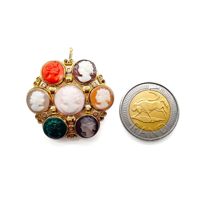 Unique 14ct yellow gold pendant/brooch set with a variety of seven small cameos, including one coral and one chrysoprase. Beautiful scroll work on setting.