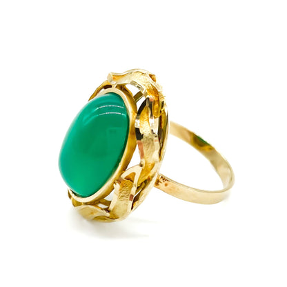 Stunning 14ct yellow gold ring set with a bright green oval chrysoprase cabochon, surrounded by a textured gold border.