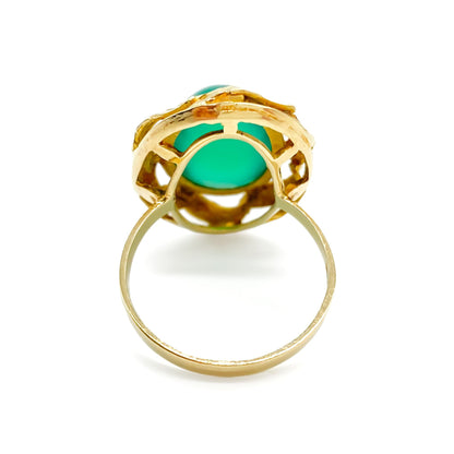 Stunning 14ct yellow gold ring set with a bright green oval chrysoprase cabochon, surrounded by a textured gold border.