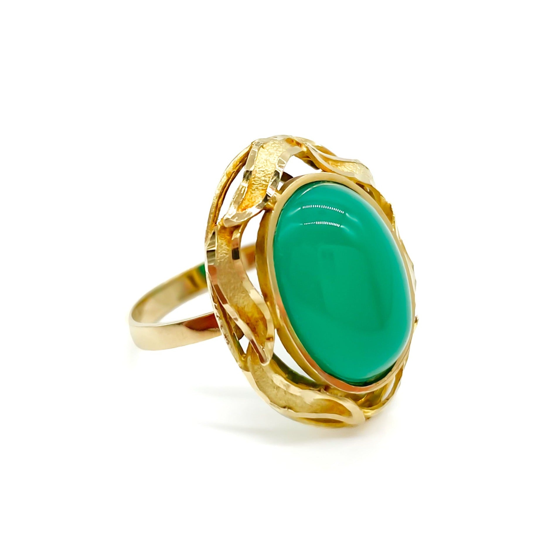 Stunning 14ct yellow gold ring set with a bright green oval chrysoprase cabochon, surrounded by a textured gold border.