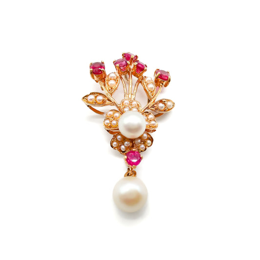 Pretty 14ct Gold pendant set with six faceted rubies, a centre pearl surrounded by seed pearls in a flower design, and a dangling pearl drop.