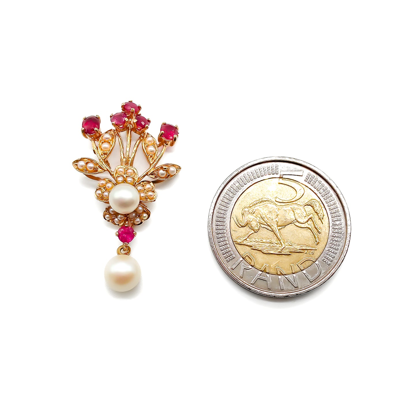 Pretty 14ct Gold pendant set with six faceted rubies, a centre pearl surrounded by seed pearls in a flower design, and a dangling pearl drop.