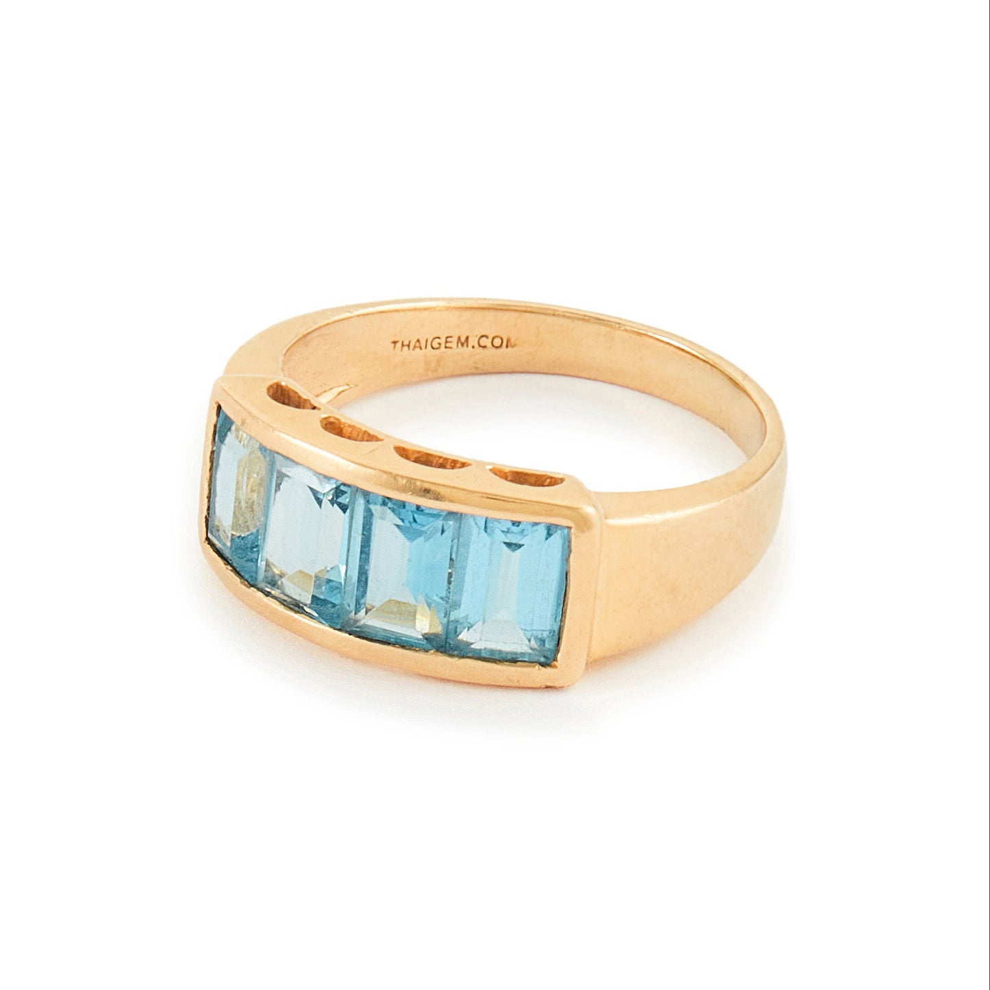 Classic 14ct yellow gold ring with four faceted, bright blue topaz stones in a channel setting.