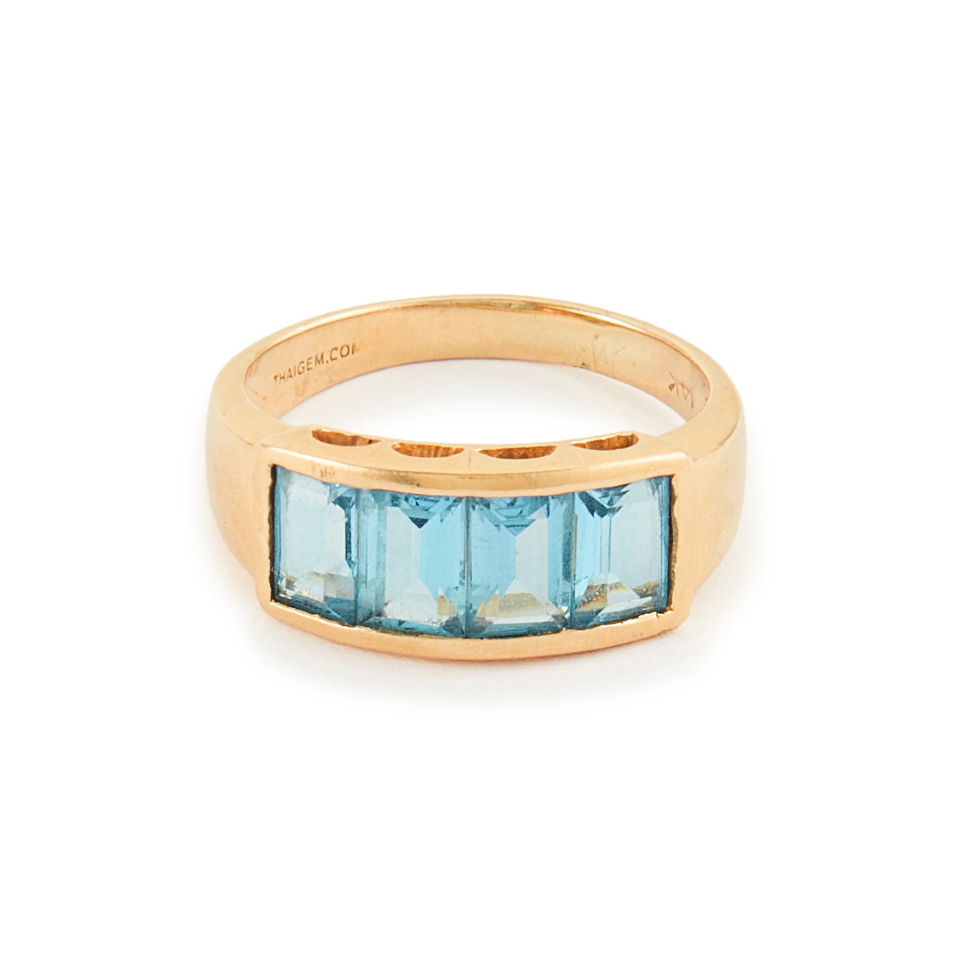 Classic 14ct yellow gold ring with four faceted, bright blue topaz stones in a channel setting.