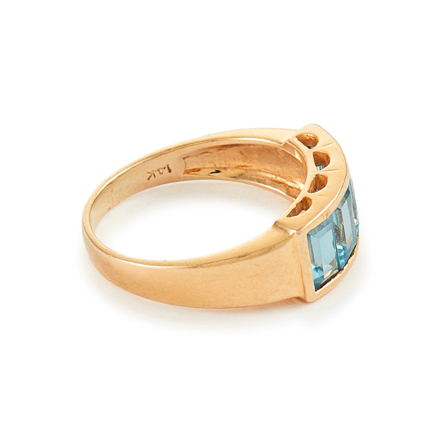 Classic 14ct yellow gold ring with four faceted, bright blue topaz stones in a channel setting.