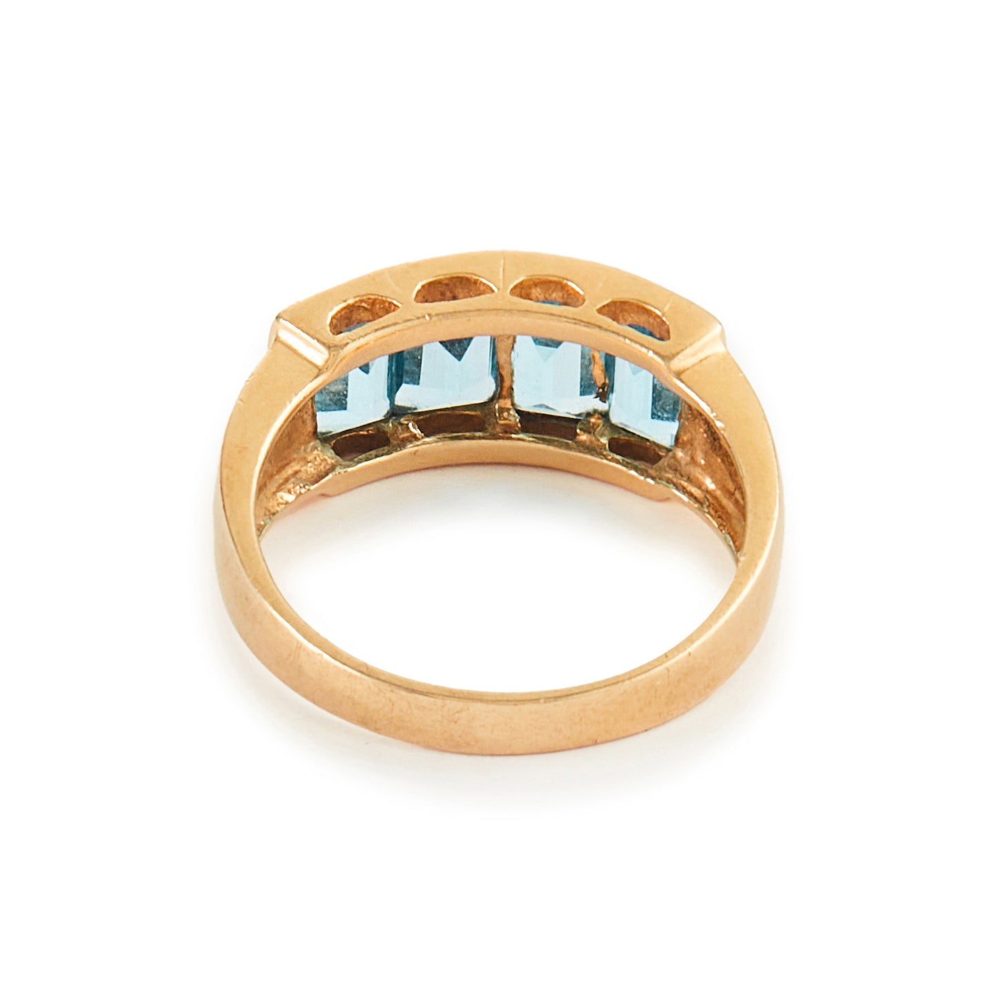 Classic 14ct yellow gold ring with four faceted, bright blue topaz stones in a channel setting.
