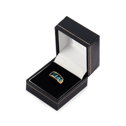 Classic 14ct yellow gold ring with four faceted, bright blue topaz stones in a channel setting.