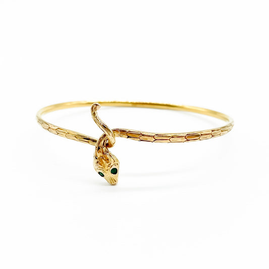 Charming 14ct gold serpent bangle with scale engraving and emerald eyes. Circa 1930's