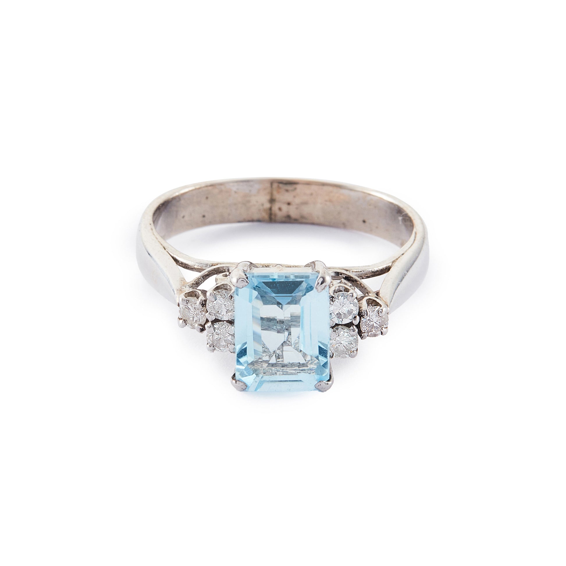 Classic vintage 14ct white gold ring set with a light blue emerald-cut aquamarine flanked by three 0.05ct diamonds on each side. Size: M½