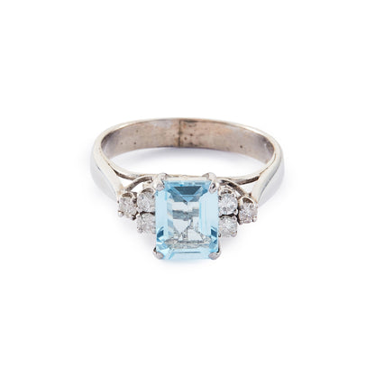 Classic vintage 14ct white gold ring set with a light blue emerald-cut aquamarine flanked by three 0.05ct diamonds on each side. Size: M½
