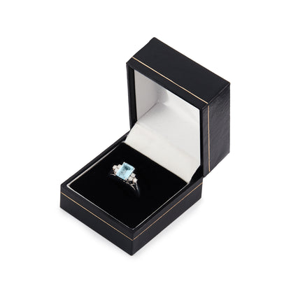 Classic vintage 14ct white gold ring set with a light blue emerald-cut aquamarine flanked by three 0.05ct diamonds on each side. Size: M½