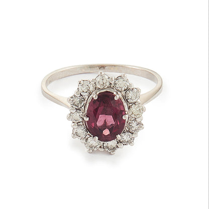 Exquisite vintage 14ct white gold ring set with a beautiful ruby-coloured rhodolite garnet surrounded by twelve natural 0.6ct diamonds.