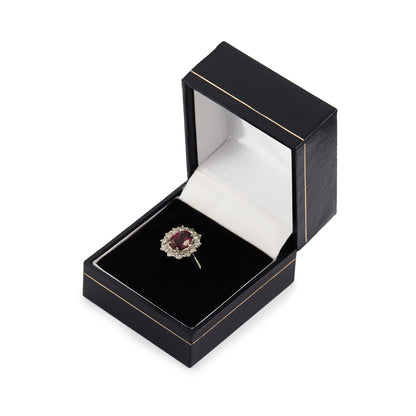 Exquisite vintage 14ct white gold ring set with a beautiful ruby-coloured rhodolite garnet surrounded by twelve natural 0.6ct diamonds.