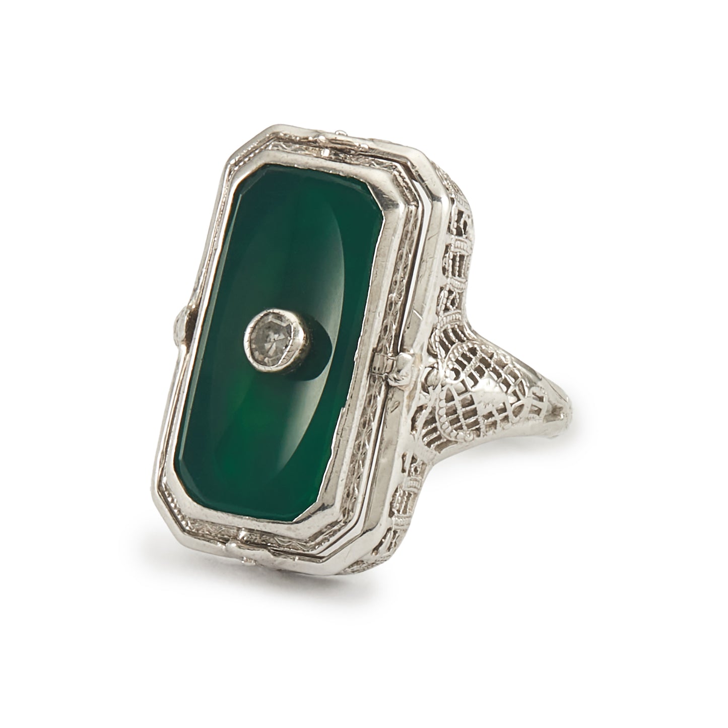 A very unusual 14ct white gold swivel ring set with a cameo of a woman wearing a diamond necklace on one side, and a green chrysoprase disc centred by a diamond on the other side. The versatile centre piece is surrounded by intricate filigree detail.