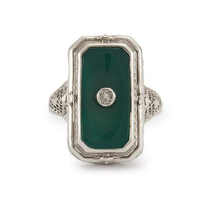 A very unusual 14ct white gold swivel ring set with a cameo of a woman wearing a diamond necklace on one side, and a green chrysoprase disc centred by a diamond on the other side. The versatile centre piece is surrounded by intricate filigree detail.