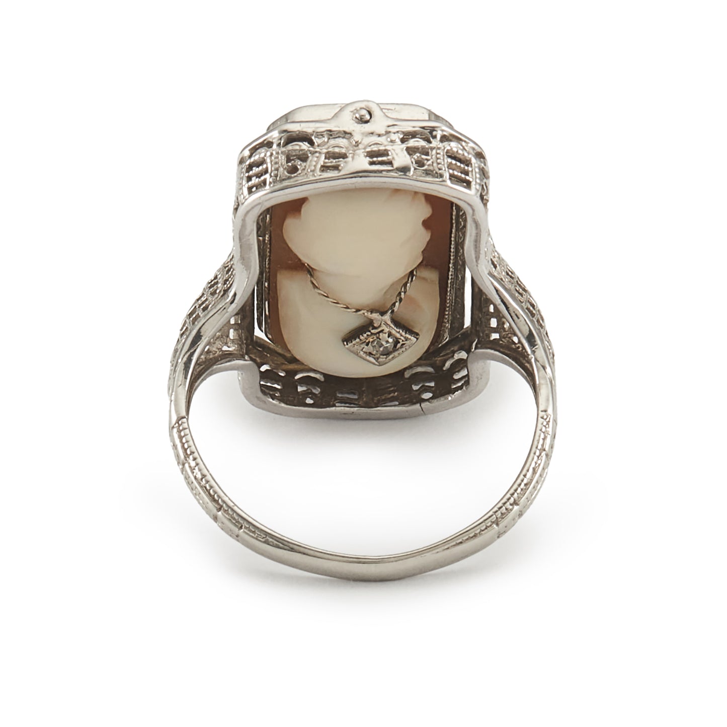 A very unusual 14ct white gold swivel ring set with a cameo of a woman wearing a diamond necklace on one side, and a green chrysoprase disc centred by a diamond on the other side. The versatile centre piece is surrounded by intricate filigree detail.