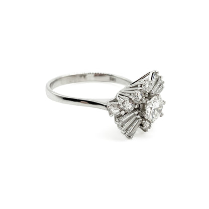 Stunning 14ct white gold vintage ring set with a centre 0.56ct round brilliant cut diamond, surrounded by eight baguette cut diamonds and eight smaller round brilliant cut diamonds.