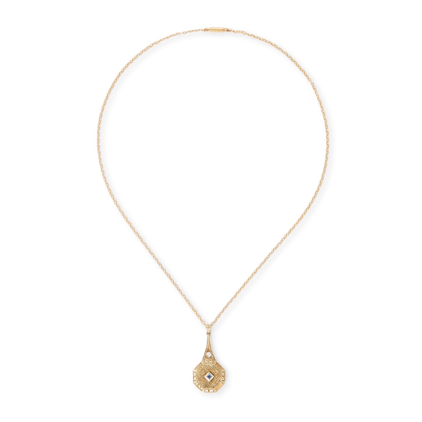 Exquisite Art Deco 15ct yellow gold pendant set with a square sapphire and a round diamond, surrounded by beautiful engraving. The pendant is on a 15ct gold belcher link chain with a barrel clasp. The compartment at the back is suitable for a picture.