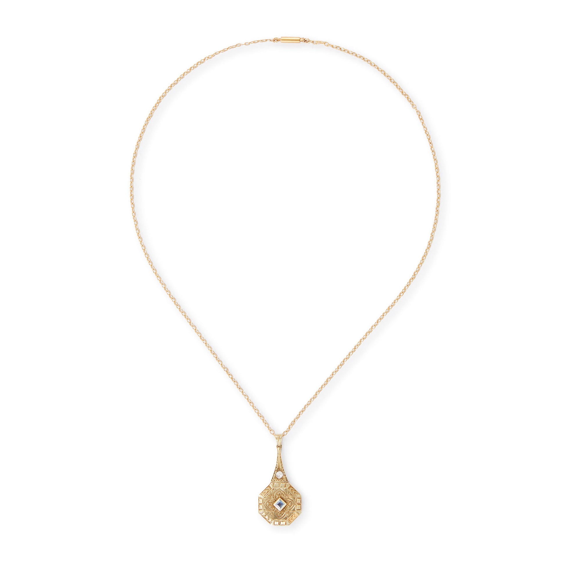 Exquisite Art Deco 15ct yellow gold pendant set with a square sapphire and a round diamond, surrounded by beautiful engraving. The pendant is on a 15ct gold belcher link chain with a barrel clasp. The compartment at the back is suitable for a picture.