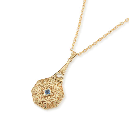 Exquisite Art Deco 15ct yellow gold pendant set with a square sapphire and a round diamond, surrounded by beautiful engraving. The pendant is on a 15ct gold belcher link chain with a barrel clasp. The compartment at the back is suitable for a picture.