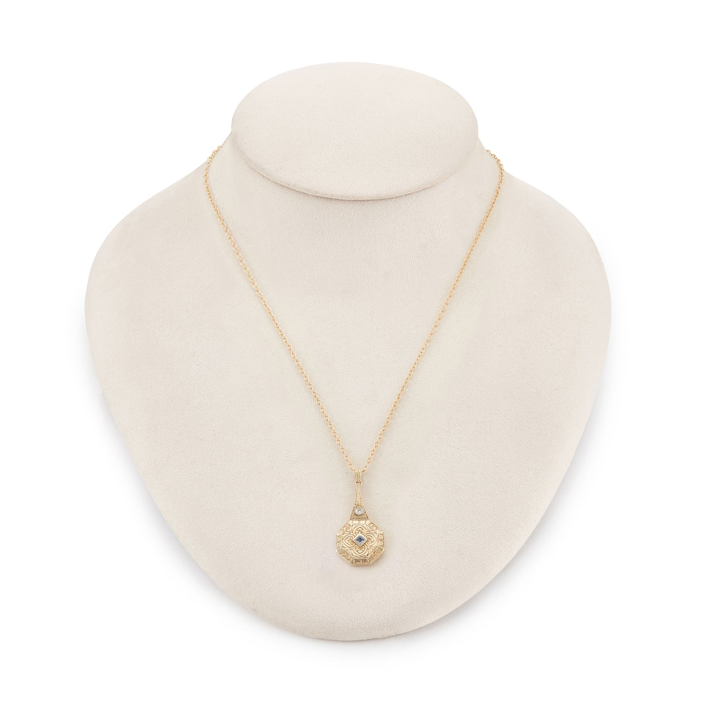 Exquisite Art Deco 15ct yellow gold pendant set with a square sapphire and a round diamond, surrounded by beautiful engraving. The pendant is on a 15ct gold belcher link chain with a barrel clasp. The compartment at the back is suitable for a picture.