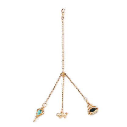 Highly sought after Victorian 15ct yellow gold attachment consisting of a dog clip, and three exquisite miniature pieces hanging from individual chains. The attachment consists of: a beautifully carved 15ct gold turquoise watch key, a 9ct gold pig charm and a 15ct gold swivel fob set with citrine, green agate and white chalcedony. Can be worn as a pendant or attached onto an Albertina.