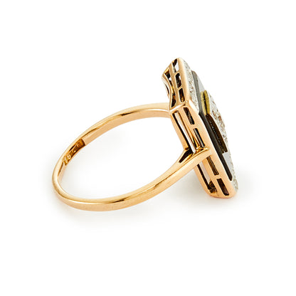 Stylish Art Deco 18ct gold ring set with an onyx disc, embellished with a centre old cut diamond, and four mine cut diamonds in a platinum setting, surrounded with smaller mine cut diamonds in a platinum setting on the edges. 